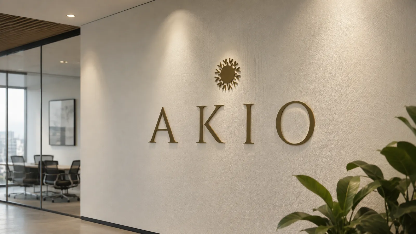 Rótulo corporativo de AKIO con letras corpóreas en latón para recepción de oficina